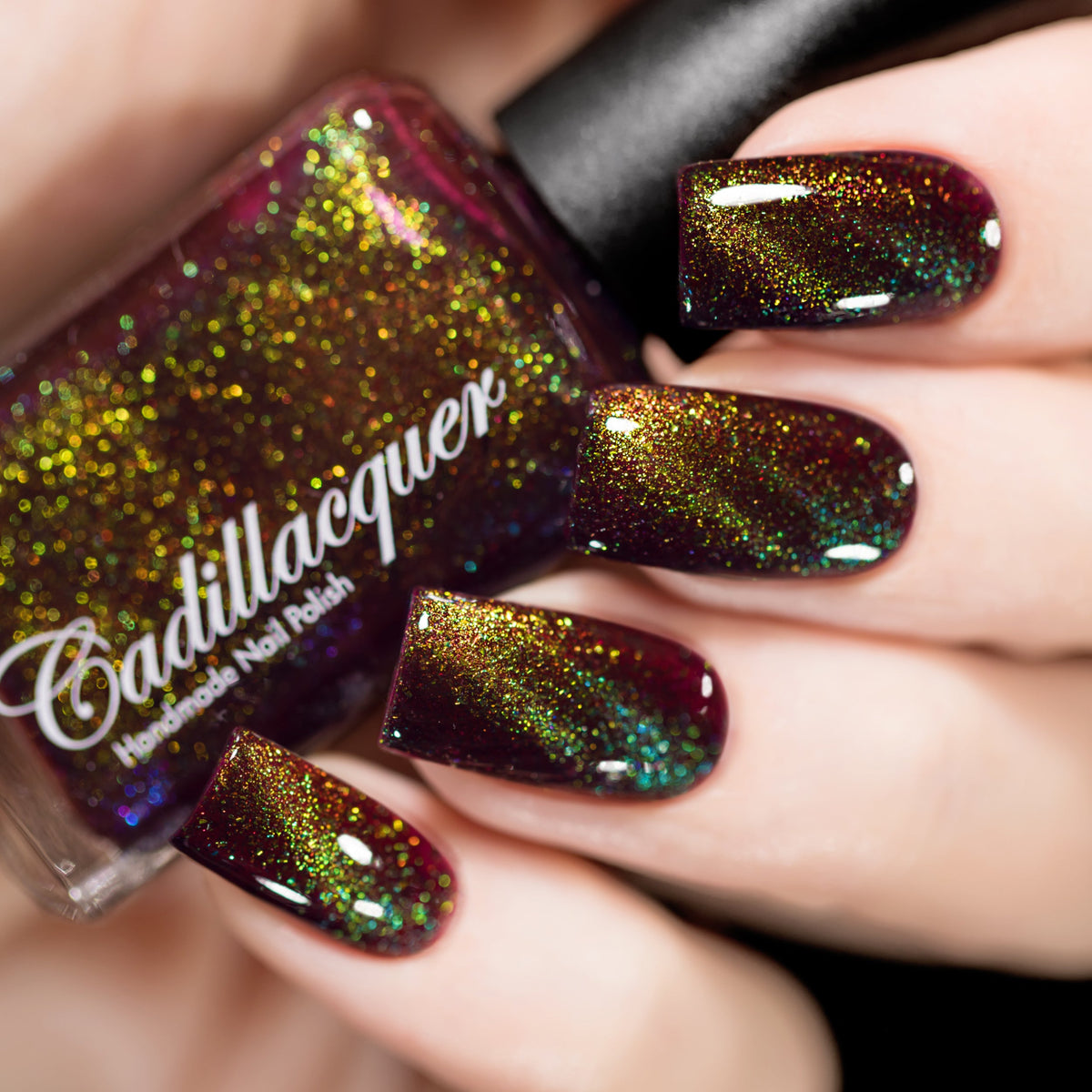 Magnetic flakie Cadillacquer nail polish in Calypso, a deep red jelly with chartreuse to green magnetic flakies, swatched by @rafinails