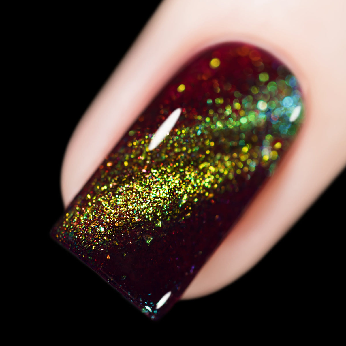 Close-up of Cadillacquer Calypso, deep red jelly nail polish with a green magnetic flakie line, swatched by @rafinails