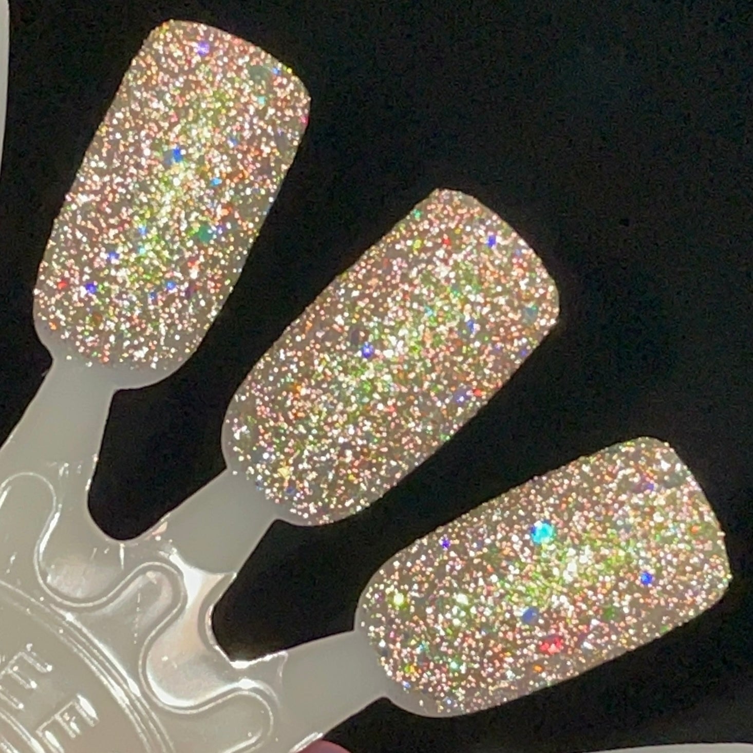 Thyme to Shine by Dam Nail Polish, green-to-pink multichrome shimmer with dense silver holographic and reflective glitters showing rainbow spectral flash, swatch stick