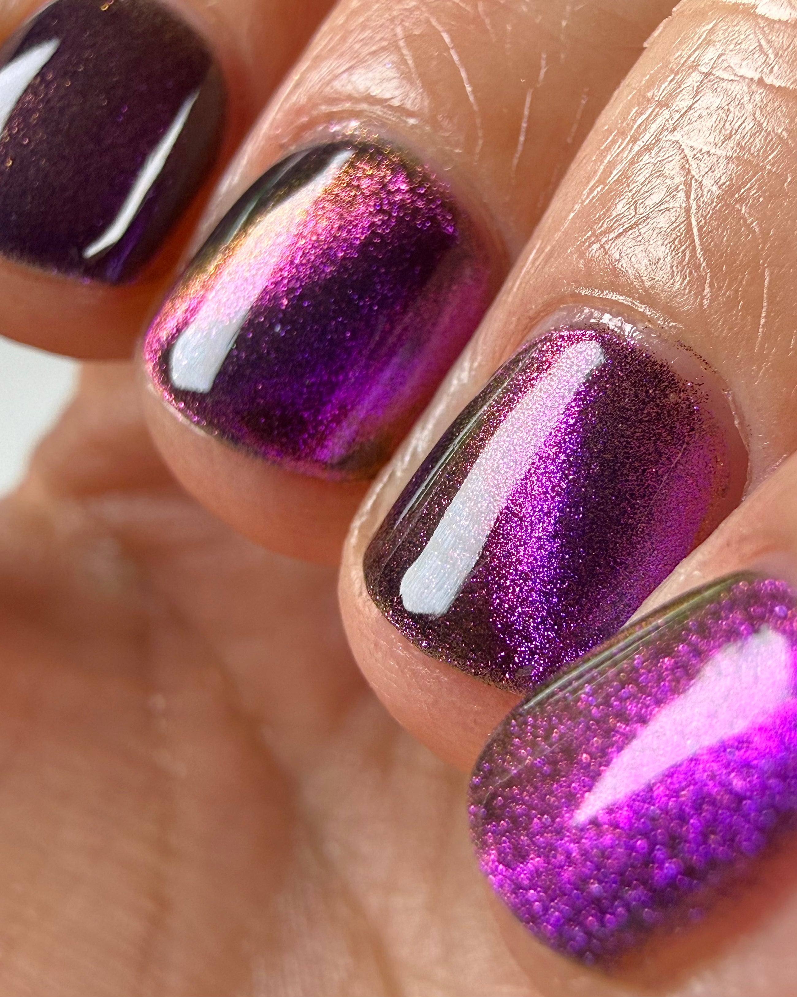 Habibi by Glitch Lacquer, dark purple-pink-gold magnetic swatch on light-medium skin, oval nails