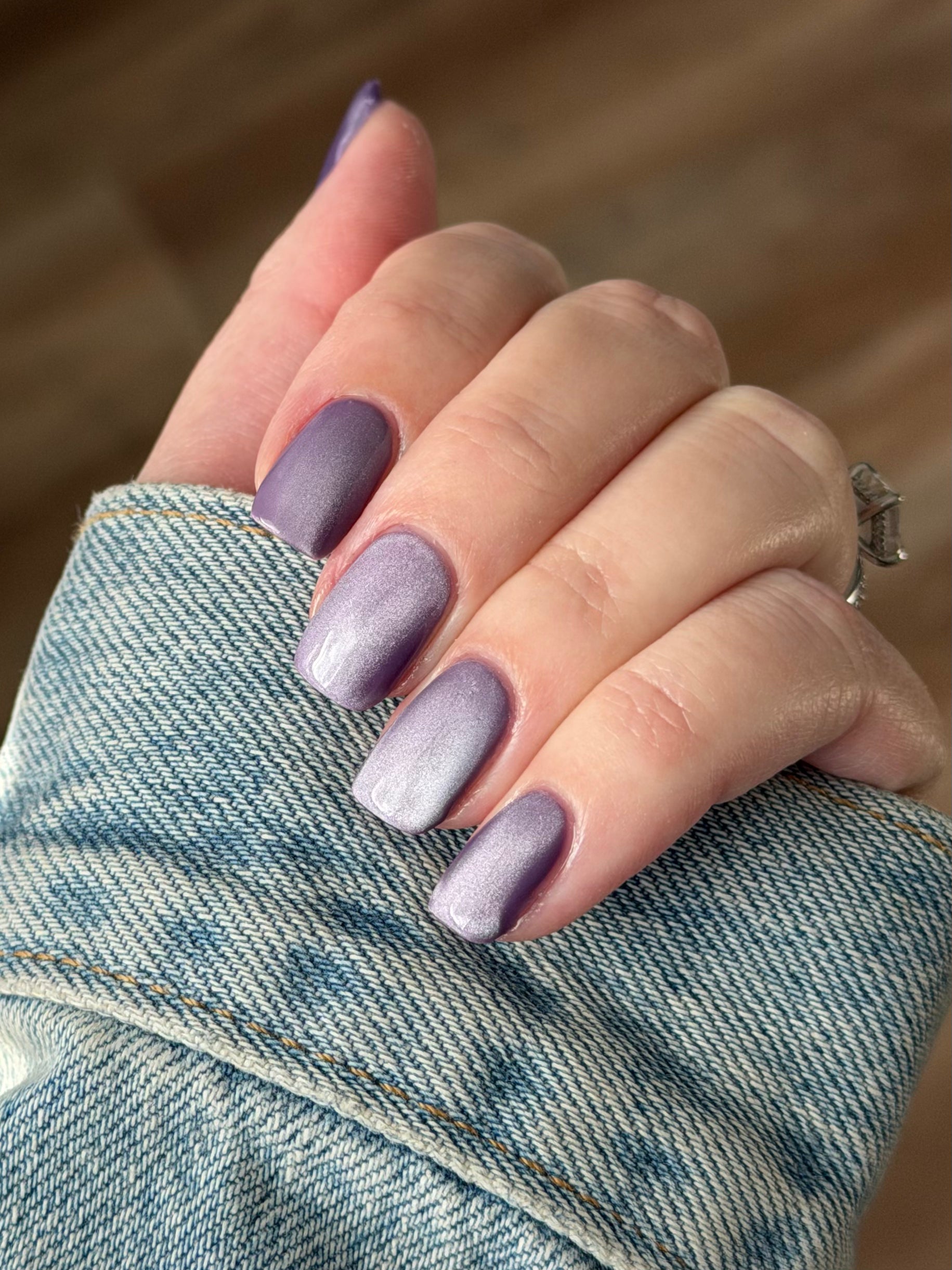 Liberation by Glitch Lacquer, lavender silver magnetic swatch against denim sleeve, light skin tone