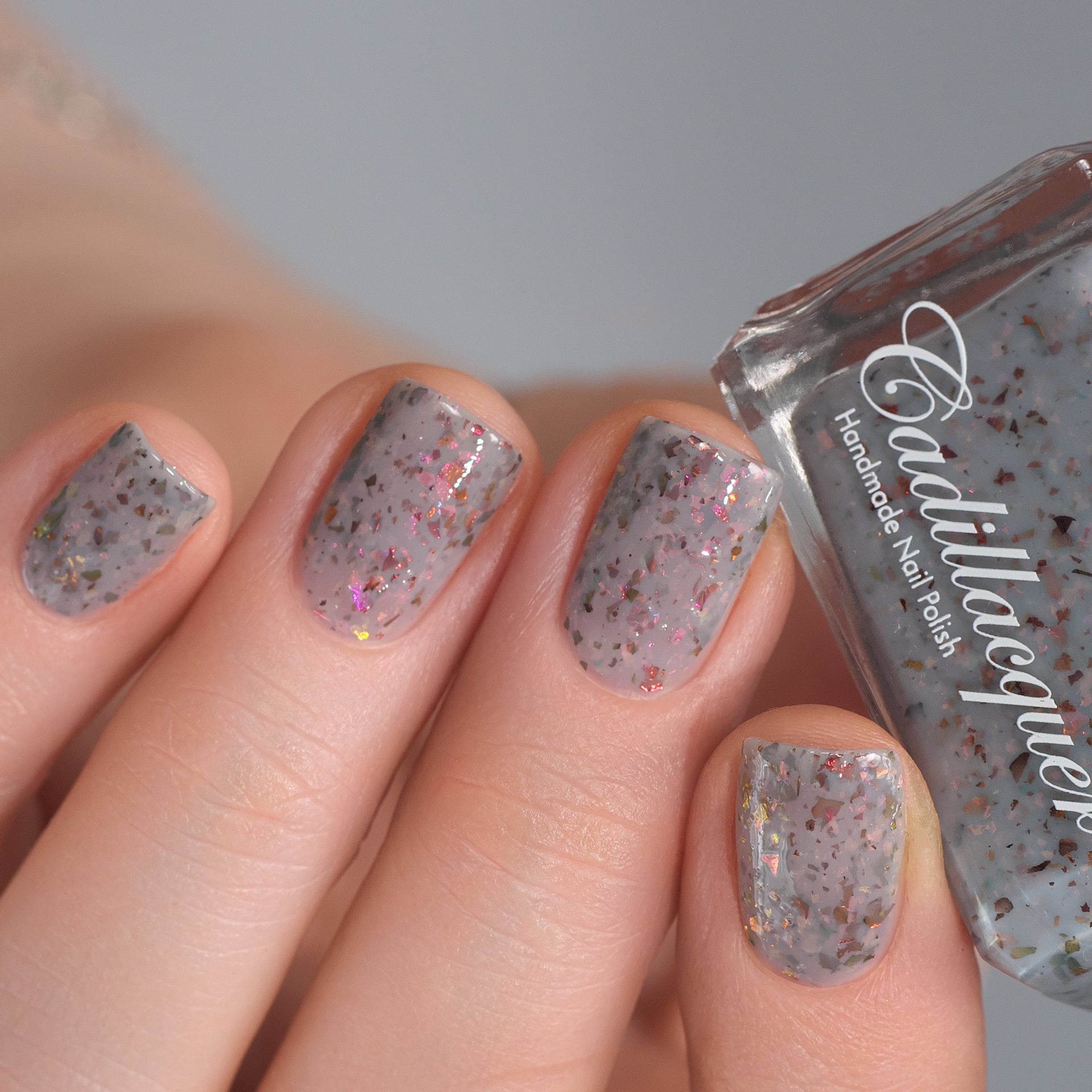 Cadillacquer Daydreaming grey red chameleon iridescent crelly nail polish, swatched on four nails, light skin, studio lighting, by @Lakodzen