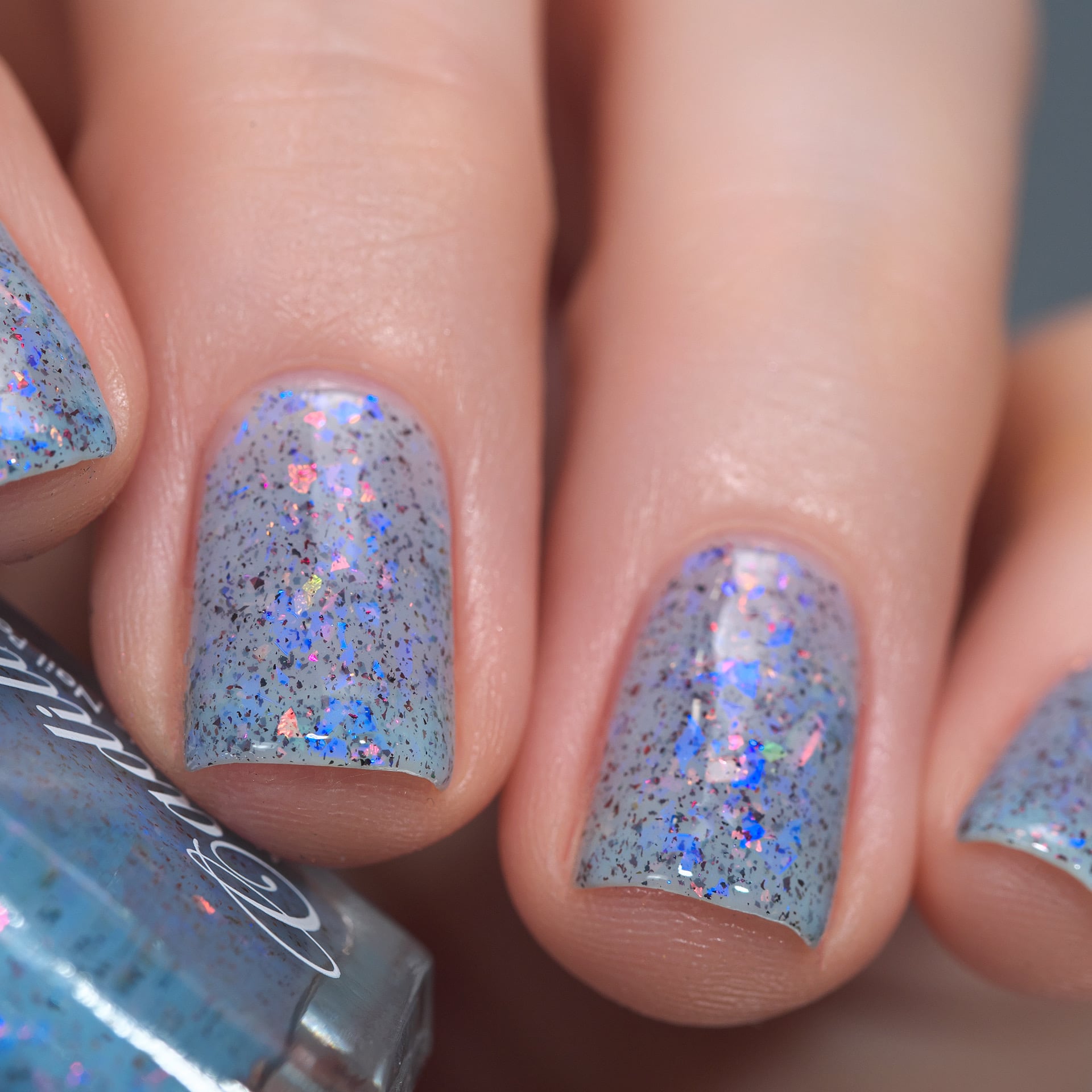 Cadillacquer Just Breathe pastel blue iridescent crelly nail polish, swatched on four nails, light skin, studio lighting, by @Lakodzen