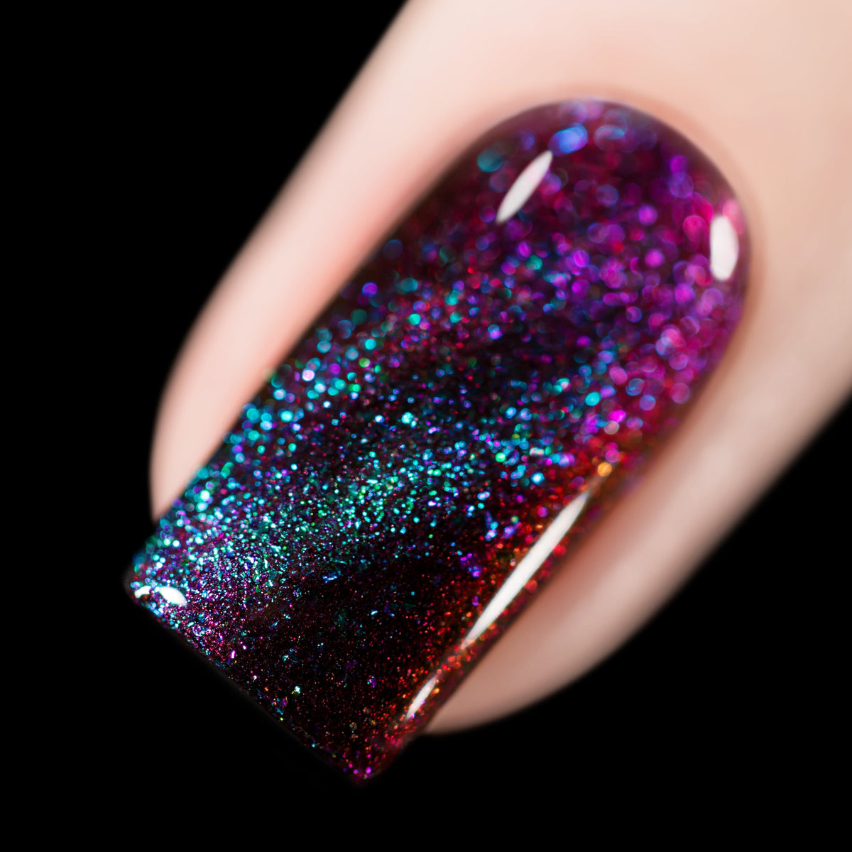 Close-up of Cadillacquer The Darkest Night nail polish showing teal and purple magnetic flakies over a black-red multichrome, swatched by @rafinails