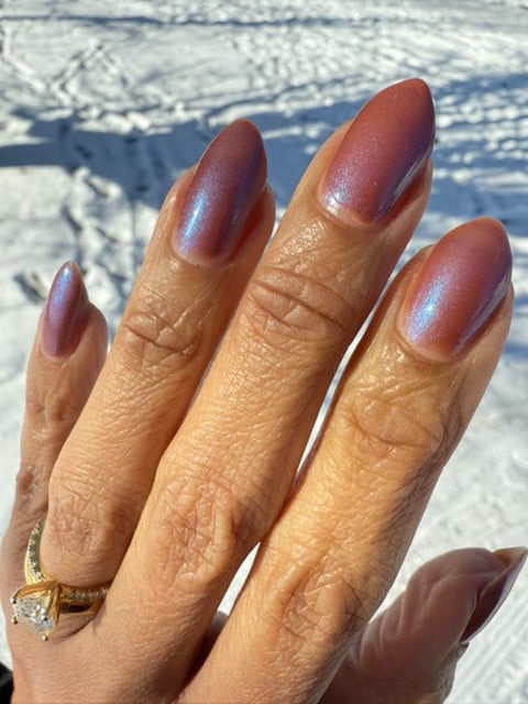Enth E ND by Danglefoot Nail Polish, blue-brown shimmer on a medium-deep skin tone hand