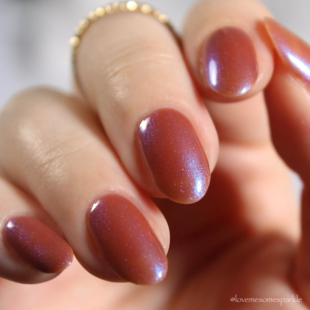Enth E ND by Danglefoot Nail Polish, blue-brown shimmer on a light skin tone hand