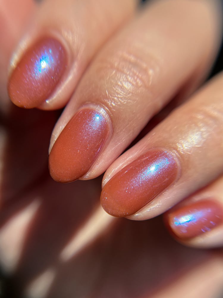 Enth E ND by Danglefoot Nail Polish, blue-brown shimmer on a light-medium skin tone hand
