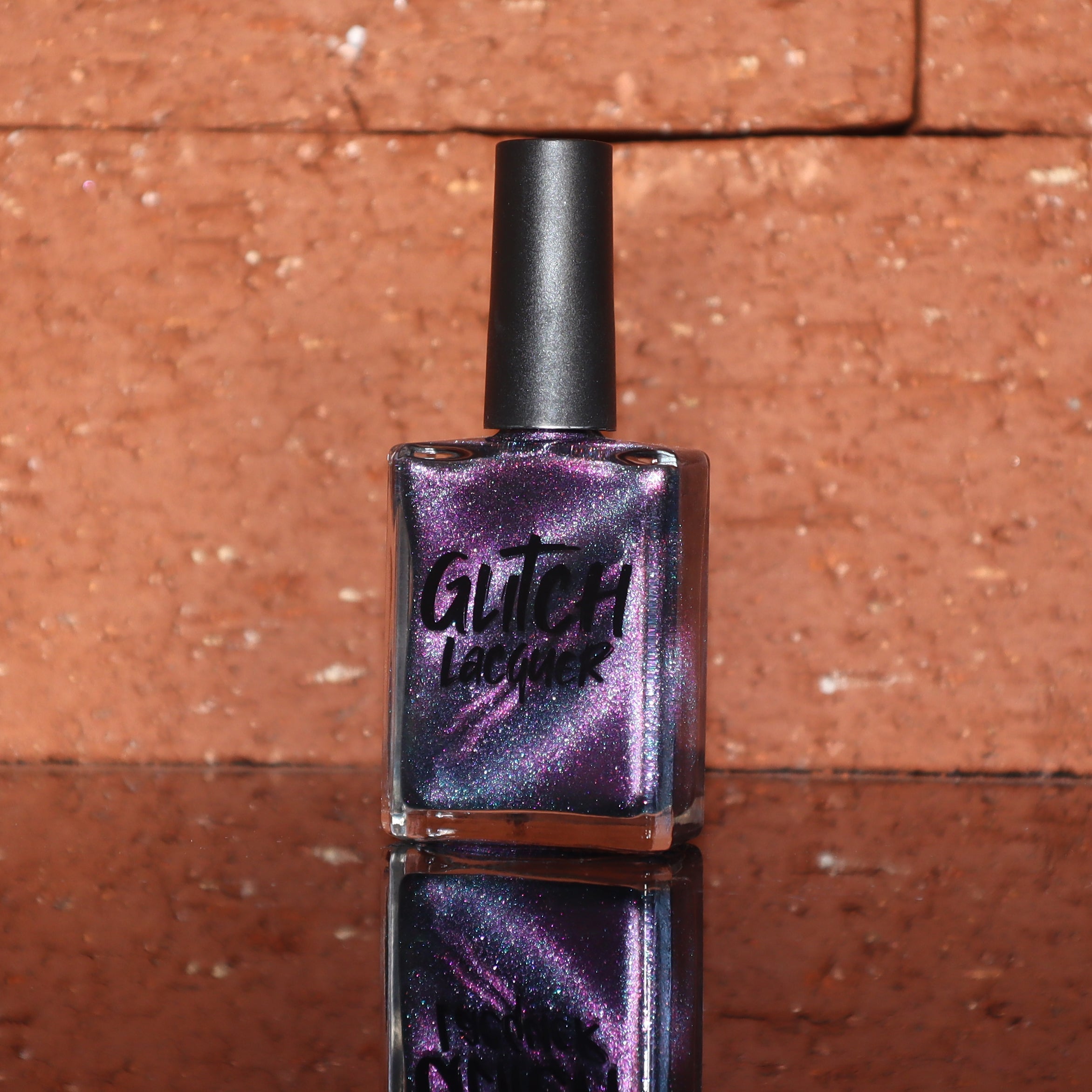 Lavender Menace by Glitch Lacquer, black jelly with purple sparkle and purple-blue magnetic, bottle