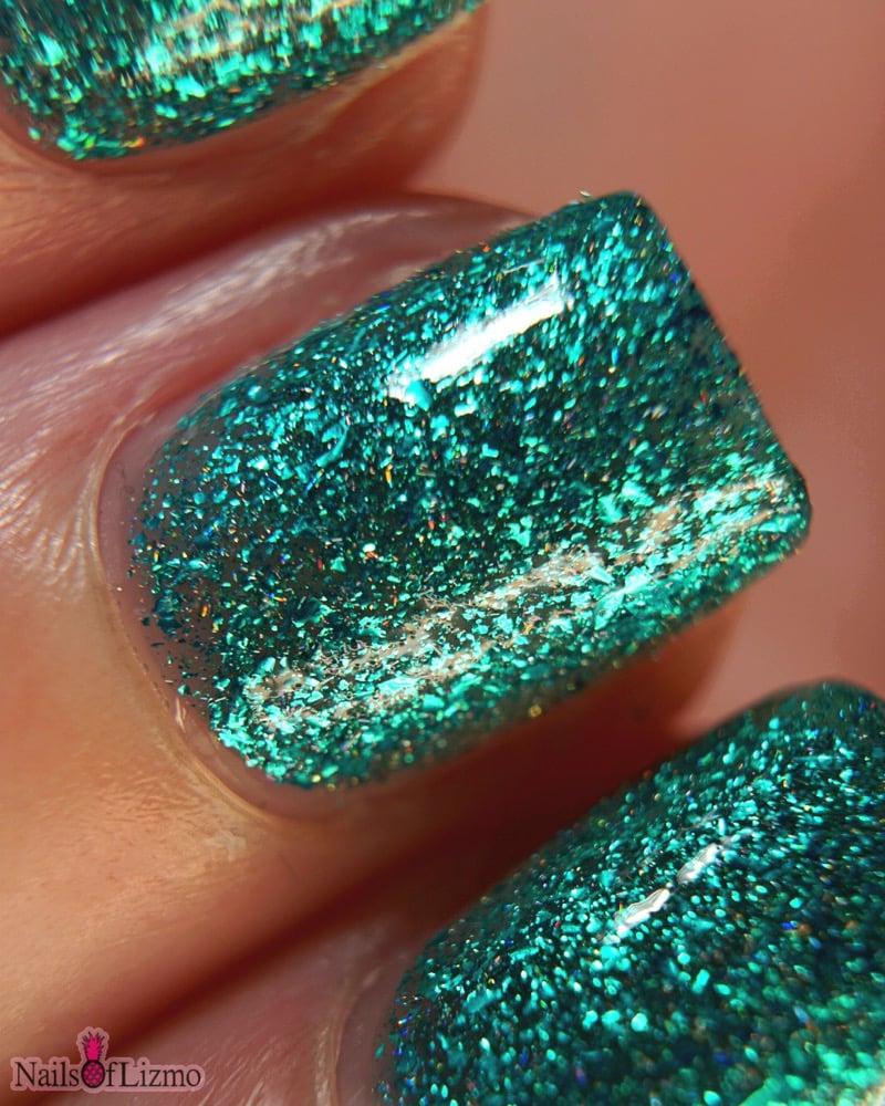 Mutant and Proud by Danglefoot Nail Polish, macro close-up of green-teal holographic reflective glitter flakie