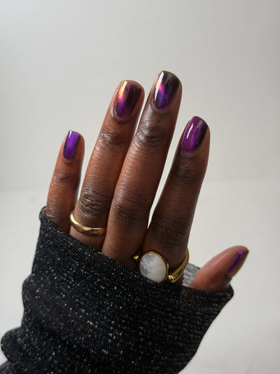 Habibi by Glitch Lacquer, dark purple-pink-gold magnetic swatch on rich skin tone, round nails