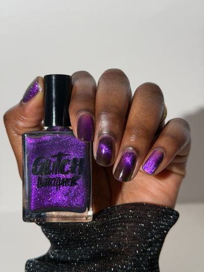 Habibi by Glitch Lacquer, dark purple-pink-gold magnetic on a deep skin tone hand