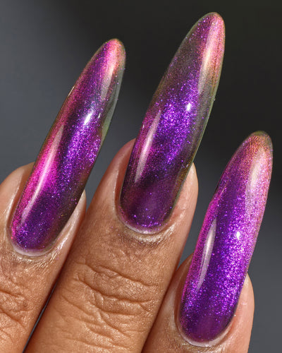 Habibi by Glitch Lacquer, dark purple-pink-gold magnetic swatch on medium-deep skin, almond nails