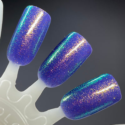 Sandman by Dam Nail Polish, cool blurple jelly densely packed with gold-to-teal-to-green color-shifting shimmer, swatch stick