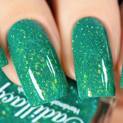 Blausee by Cadillacquer, teal green crelly with light blue reflective micro-glitter and yellow-green multichrome flakes showing full complexity under studio light, on a light-medium skin tone hand