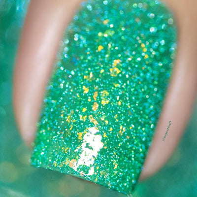 Blausee by Cadillacquer, macro close-up of vivid teal green crelly showing dense yellow-green iridescent flakes and holographic blue-green reflective micro-glitter in bright daylight