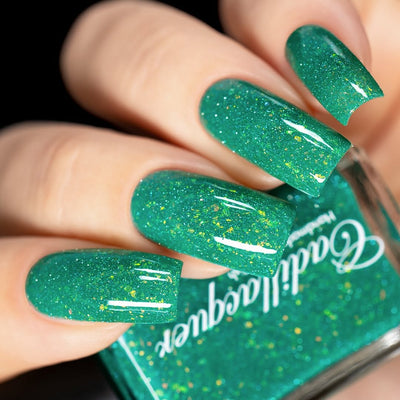Blausee by Cadillacquer, teal green reflective glitter flakie crelly with dense yellow-green flakes and light blue shimmer scatter, on a light skin tone hand
