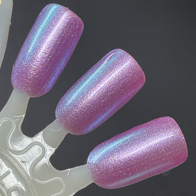 Stay Frosty My Friends by Dam Nail Polish, soft lavender-purple base with cool teal pearlescent shimmer shift, swatch stick