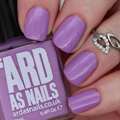Dusk by 'Ard As Nails, medium lavender purple creme, bottle held in a light hand