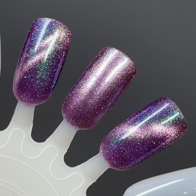Moonlight Mist by Dam Nail Polish, deep purple holographic magnetic with pink cat-eye streak and blue-green shifting shimmer, swatch stick