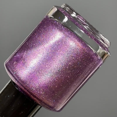 Moonlight Mist by Dam Nail Polish, deep mauve-purple magnetic with vivid pink-lavender magnetic sweep and silver-blue holographic dust, bottle standalone product shot