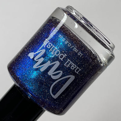 Robots Don't Poop by Dam Nail Polish, deep purple base with electric blue multichrome shift and silver reflective micro-glitter, bottle standalone product shot