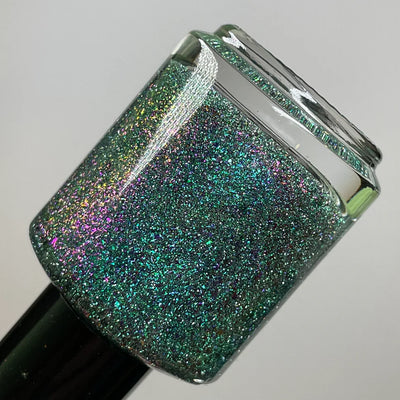 Permit to Hermit by Dam Nail Polish, deep teal reflective shimmer glitter with vivid pink-purple multichrome flakie shift, bottle standalone product shot