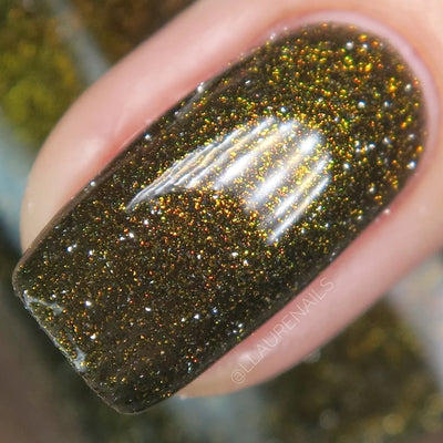 Champagne Sparkles by Dam Nail Polish, macro close-up of black jelly base with bronze-gold shimmer and gold reflective glitter sparking orange, red, and green at the edges