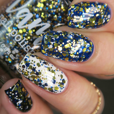 Kintsugi by Dam Nail Polish, black-blue glitter topper layered over royal blue and white creme bases showing gold, blue, and white chunky hex glitter mix, layering demo