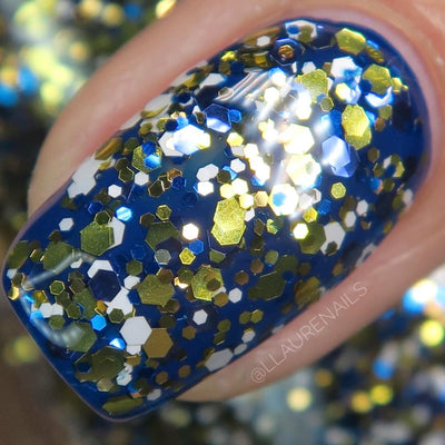 Kintsugi by Dam Nail Polish, macro close-up of densely packed metallic gold, cobalt blue, and opaque white hexagonal glitter particles of mixed sizes