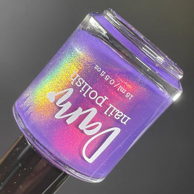 Roe, Roe, Roe Your Vote by Dam Nail Polish, blue-leaning purple multichrome shimmer showing vivid red, gold, and green shift across bottle surface, bottle standalone product shot