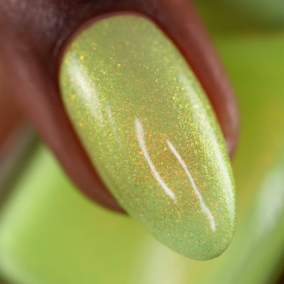 The Last Ray of Dying Light by Cadillacquer, macro close-up of dense red-orange to gold shimmer flakes over a soft yellow-green jelly base in bright daylight