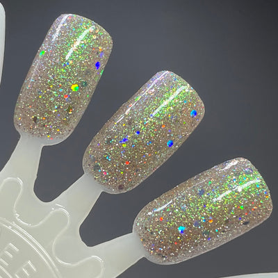 Thyme to Shine by Dam Nail Polish, green-to-purple shifting shimmer with silver micro-glitter and large multicolour holographic flakes in studio light, swatch stick