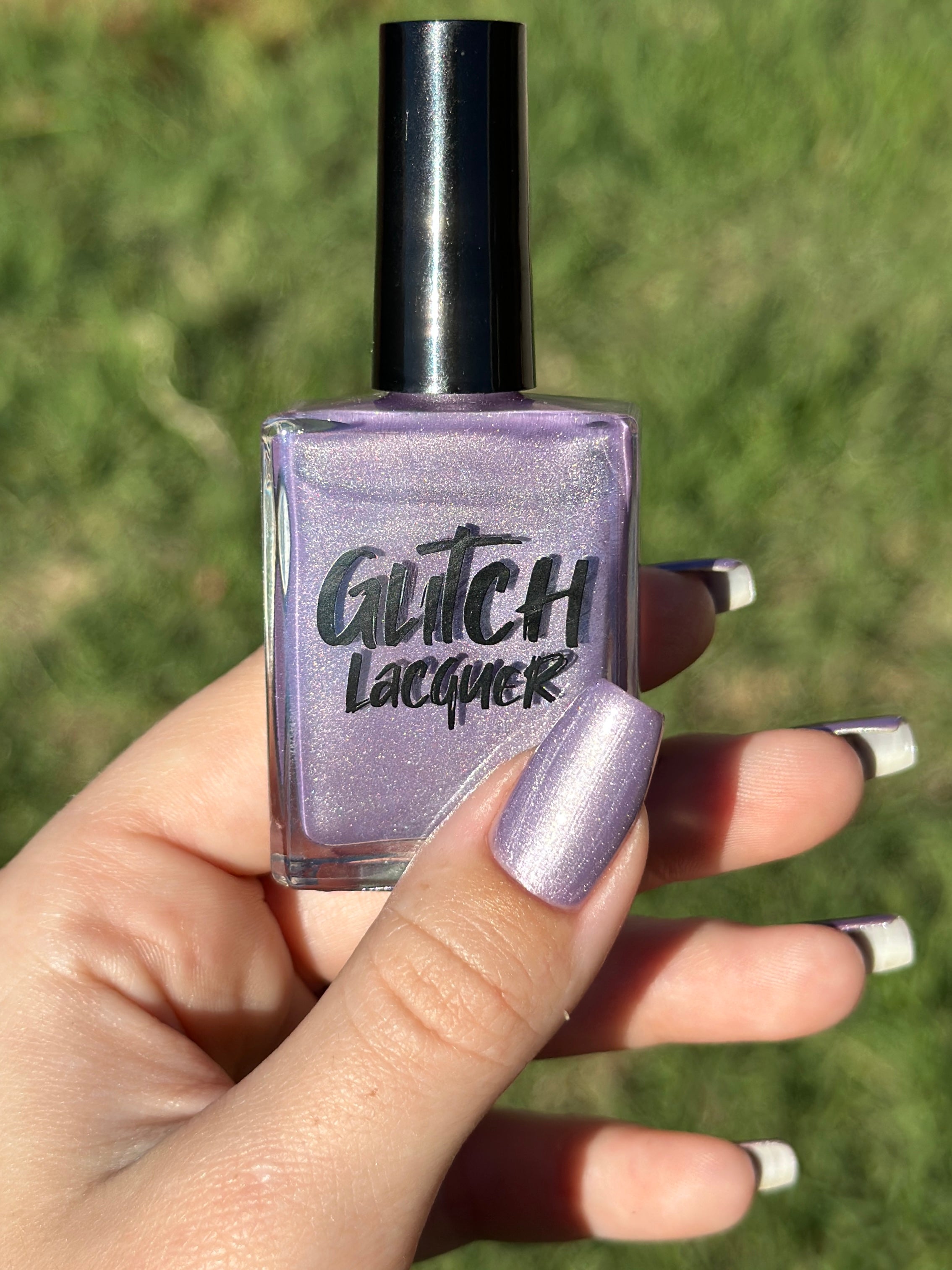 Liberation by Glitch Lacquer, lavender silver magnetic bottle and swatch on light-medium skin tone
