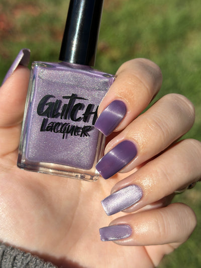 Liberation by Glitch Lacquer, lavender silver magnetic bottle and swatch, light-medium skin tone