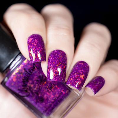 Evening in Provence by Chamaeleon Nails, magenta-purple jelly packed with orange, copper, and gold multichrome UCC flakies, bottle held in a light hand