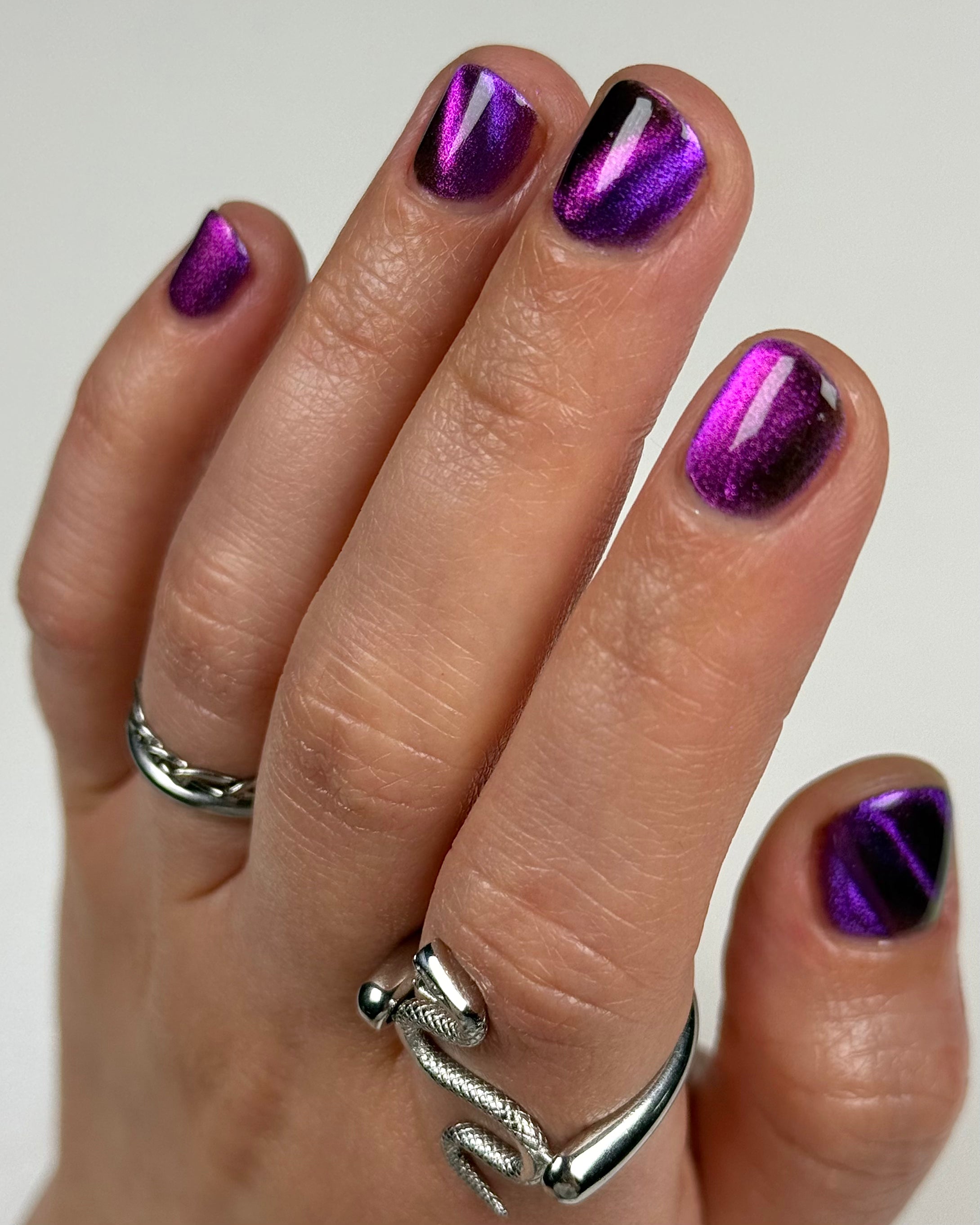 Habibi by Glitch Lacquer, dark purple-pink-gold magnetic swatch on light-medium skin, short nails