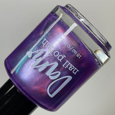 Stay Frosty My Friends by Dam Nail Polish, medium purple base showing lavender-pink shimmer and duochrome teal shift, bottle standalone product shot