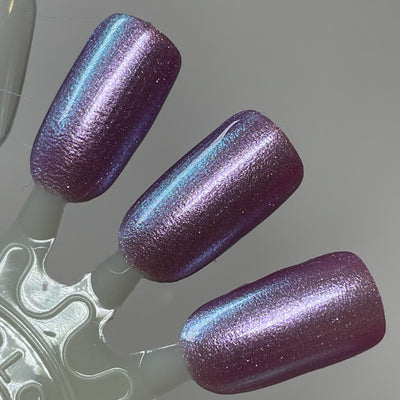 Stay Frosty My Friends by Dam Nail Polish, deep dusty purple base with pearlescent lavender highlights and striking teal multichrome shift, swatch stick