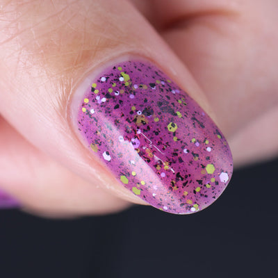 AHHHH The Flakies by Dam Nail Polish, macro close-up of large black flakie shards, chartreuse and white iridescent hex glitters in a purple-magenta jelly base