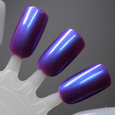 A Grave Mistake by Dam Nail Polish, deep magenta-purple base with blue-shifting iridescent shimmer, swatch stick