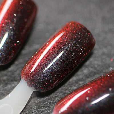 Halloween Quad Full Set by Dam Nail Polish, Hellfire deep crimson-to-black base with dense red and rainbow holographic reflective glitter, swatch stick