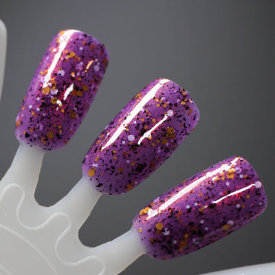 AHHHH The Flakies by Dam Nail Polish, purple jelly showing chunky black flakies and gold, white hex glitters with red-orange shimmer throughout, swatch stick