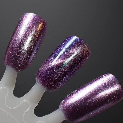 Moonlight Mist by Dam Nail Polish, deep dusty purple magnetic with sweeping pink linear magnetic effect and green-teal shimmer shift, swatch stick