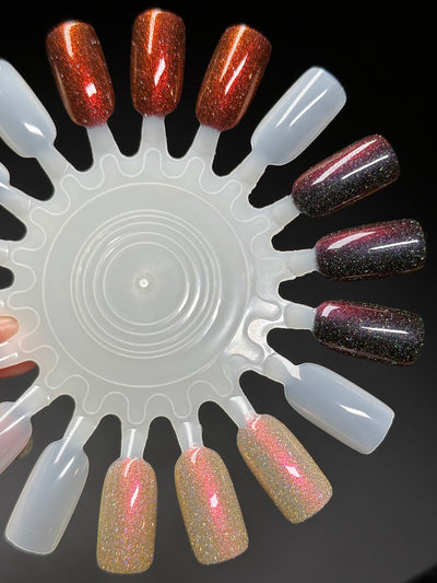 I'm Not Smart Enough by Dam Nail Polish, deep red multichrome with red-orange angular shimmer shift and reflective glitter scatter at varying angles, swatch wheel