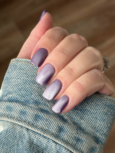 Liberation by Glitch Lacquer, lavender silver magnetic swatch against denim sleeve, light skin tone
