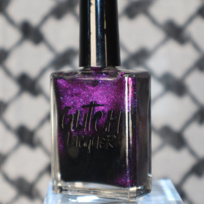 Habibi by Glitch Lacquer, dark magnetic bottle close-up on blurred keffiyeh background