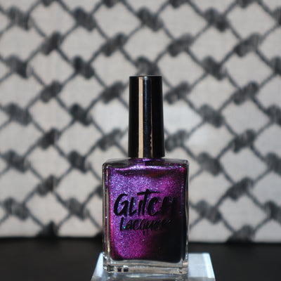 Habibi by Glitch Lacquer, dark purple-pink-gold magnetic bottle on keffiyeh-patterned background