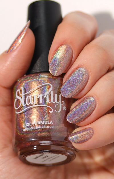 Pi Day Gift Set (Limited Edition) by Starrily, warm rose-taupe base with intense spectral linear holographic scatter, bottle held in a light skin tone hand