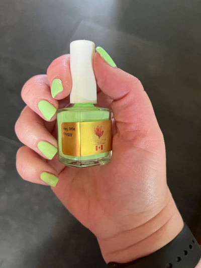 Hey, Little Froggy by Prairie Crocus Polish, soft pale mint green creme in bright daylight, bottle held in a light hand