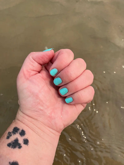 Sea Foam by Prairie Crocus Polish, vibrant aqua teal creme with warm indoor cast deepening the tone, on a light skin tone hand